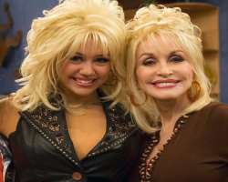 Dolly Parton is Miley's Godmother. Who also initially directed her to Jason Morey of Morey Management Group to get right help in her music career.